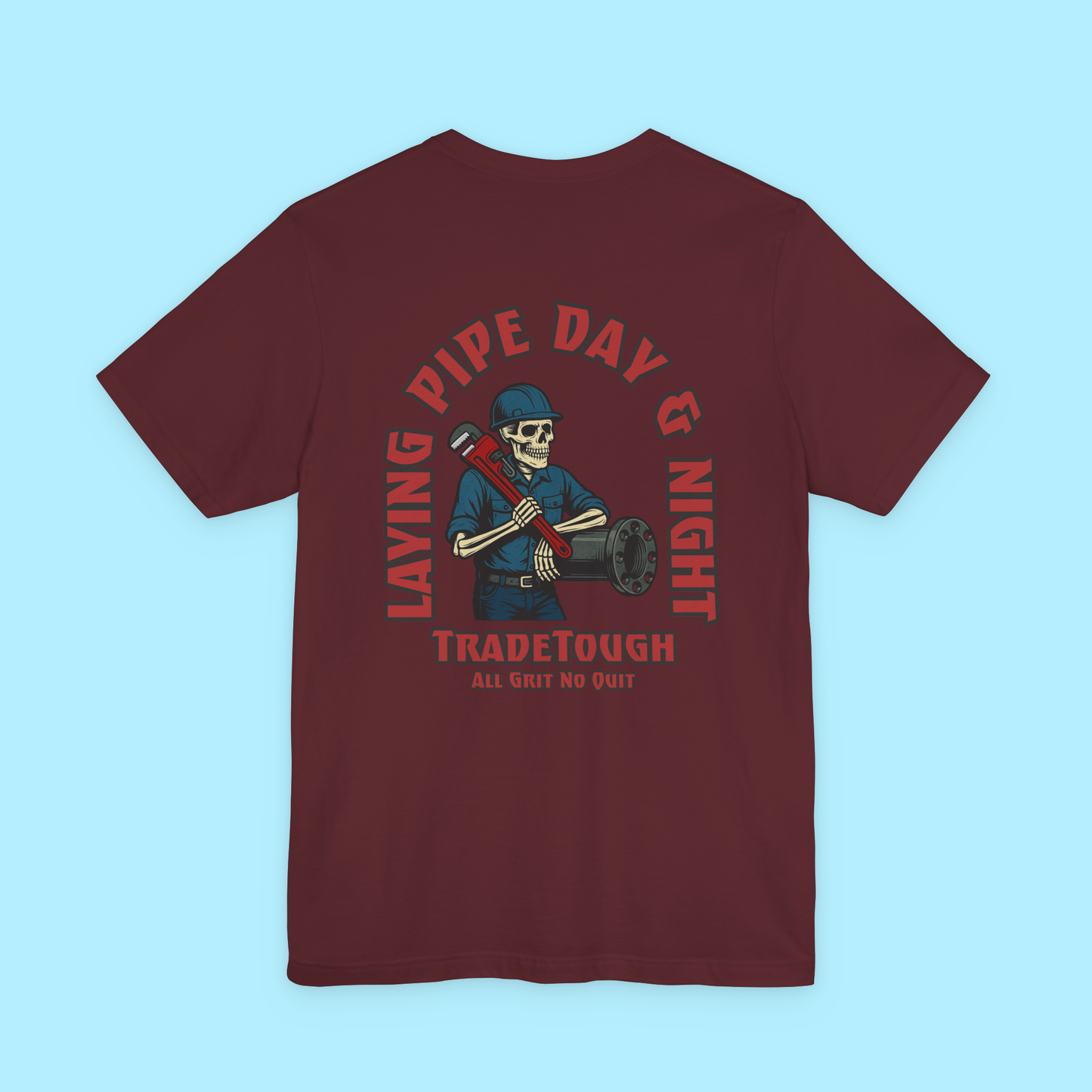 Skeleton graphic and "Layin’ Pipe Day & Night" slogan printed on back of maroon tee