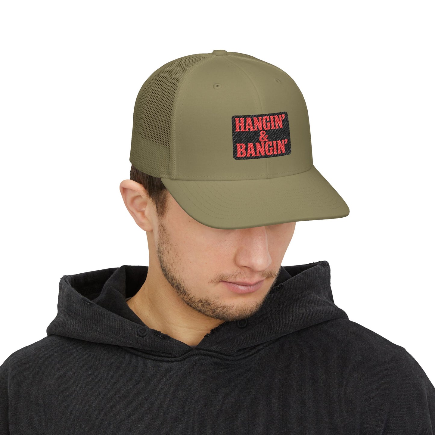 Embroidered patch detail of Hangin’ & Bangin’ design on mesh-back Richardson cap – bold red stitching on black