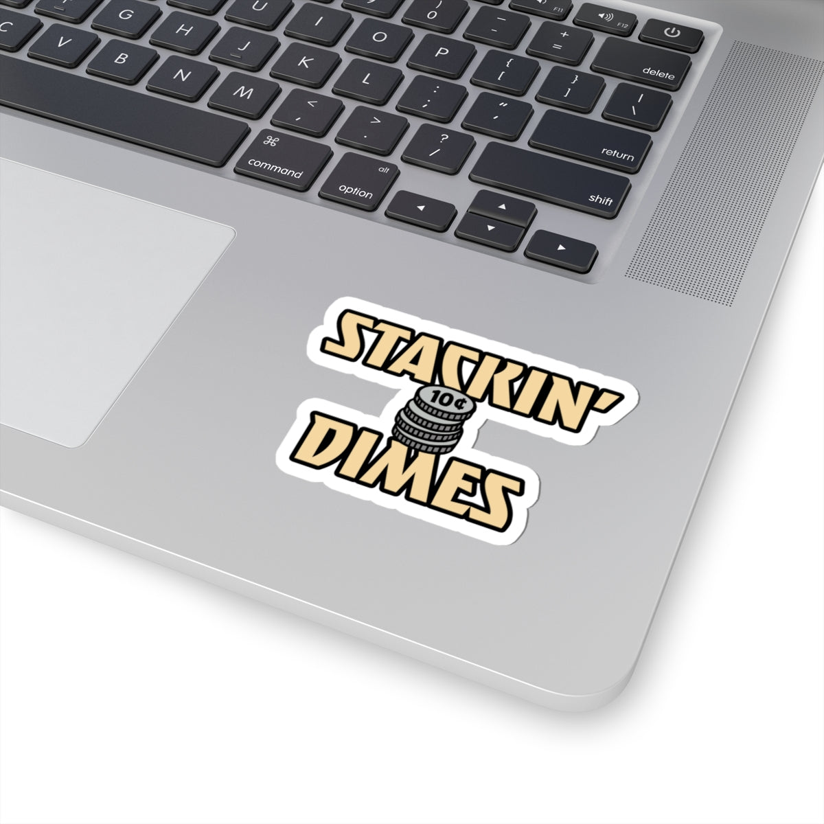 Laptop with a 'Stackin' Dimes' sticker on the palm rest area