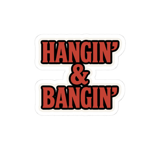 Bold red “Hangin’ & Bangin’” vinyl sticker with white outline, placed on silver laptop – tradesman decal for hardhats, toolboxes, or jobsite gear