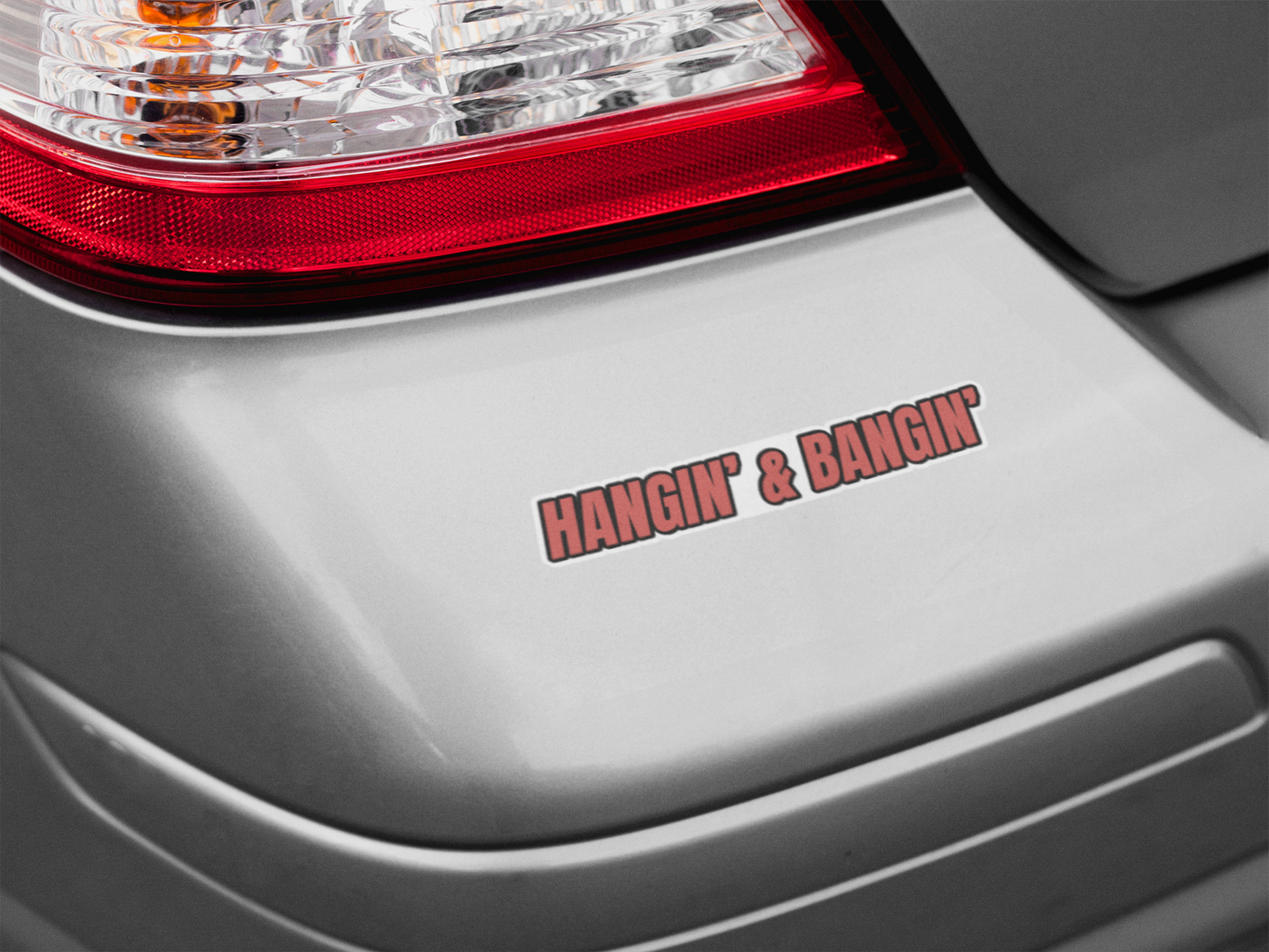 Hangin’ & Bangin’ one-line sticker on silver car bumper – bold red tradesman decal with white border