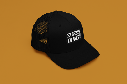 Black cap with 'Stackin' Dimes' logo on a brown background