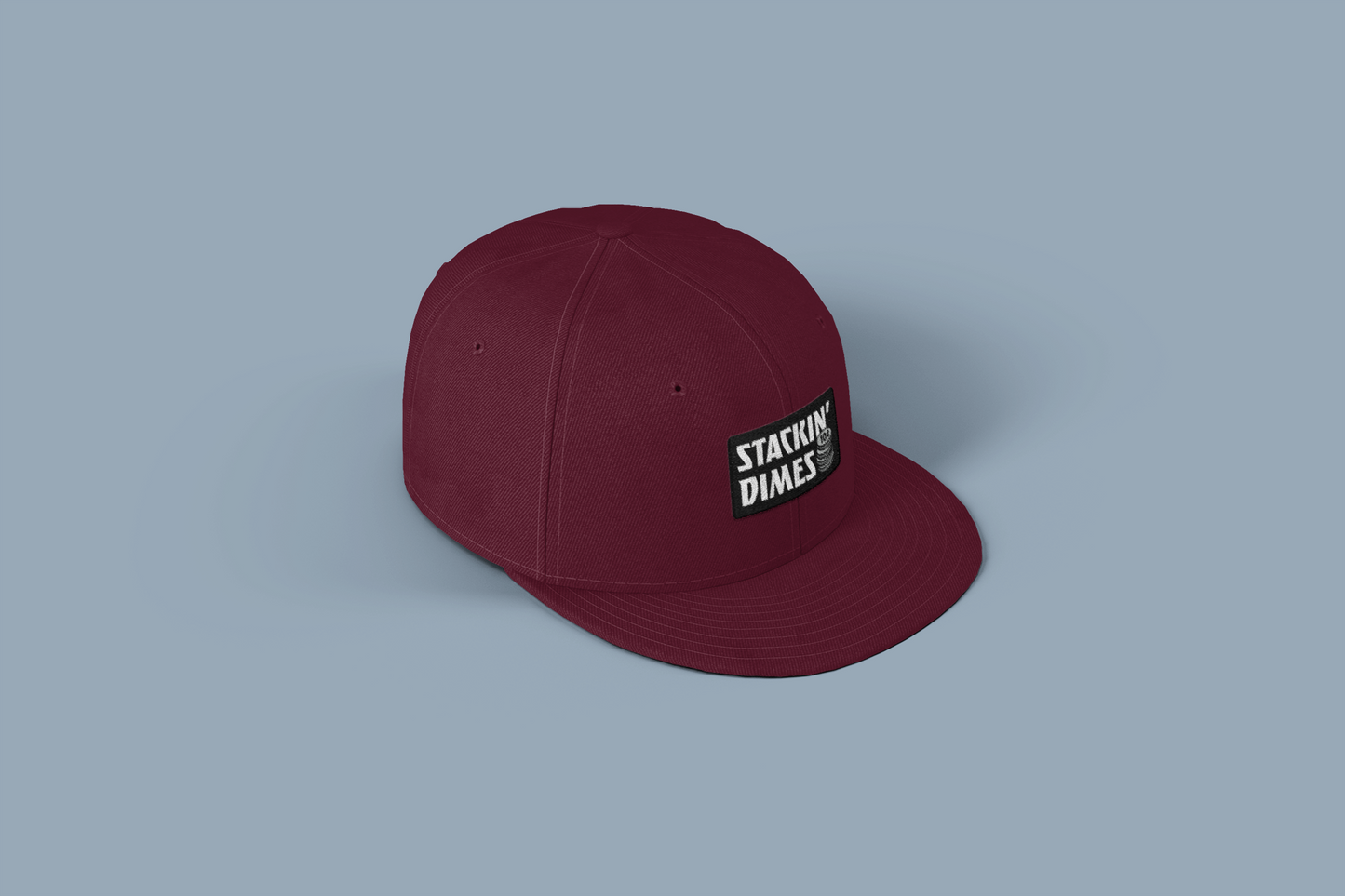 Maroon cap with a logo on a light gray background