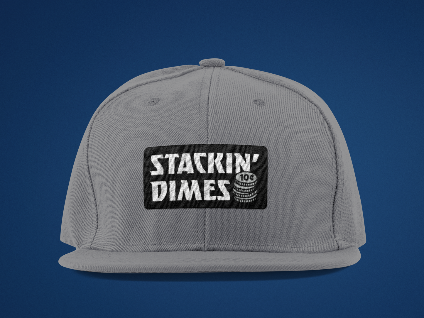 Gray cap with 'Stackin' Dimes' logo on a blue background