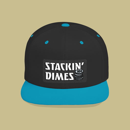 Black and blue cap with 'Stackin Dimes' logo on a beige background