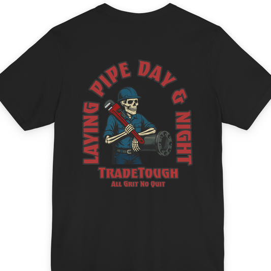 Layin’ Pipe Day & Night skeleton graphic on black shirt with red wrench and bold arch
