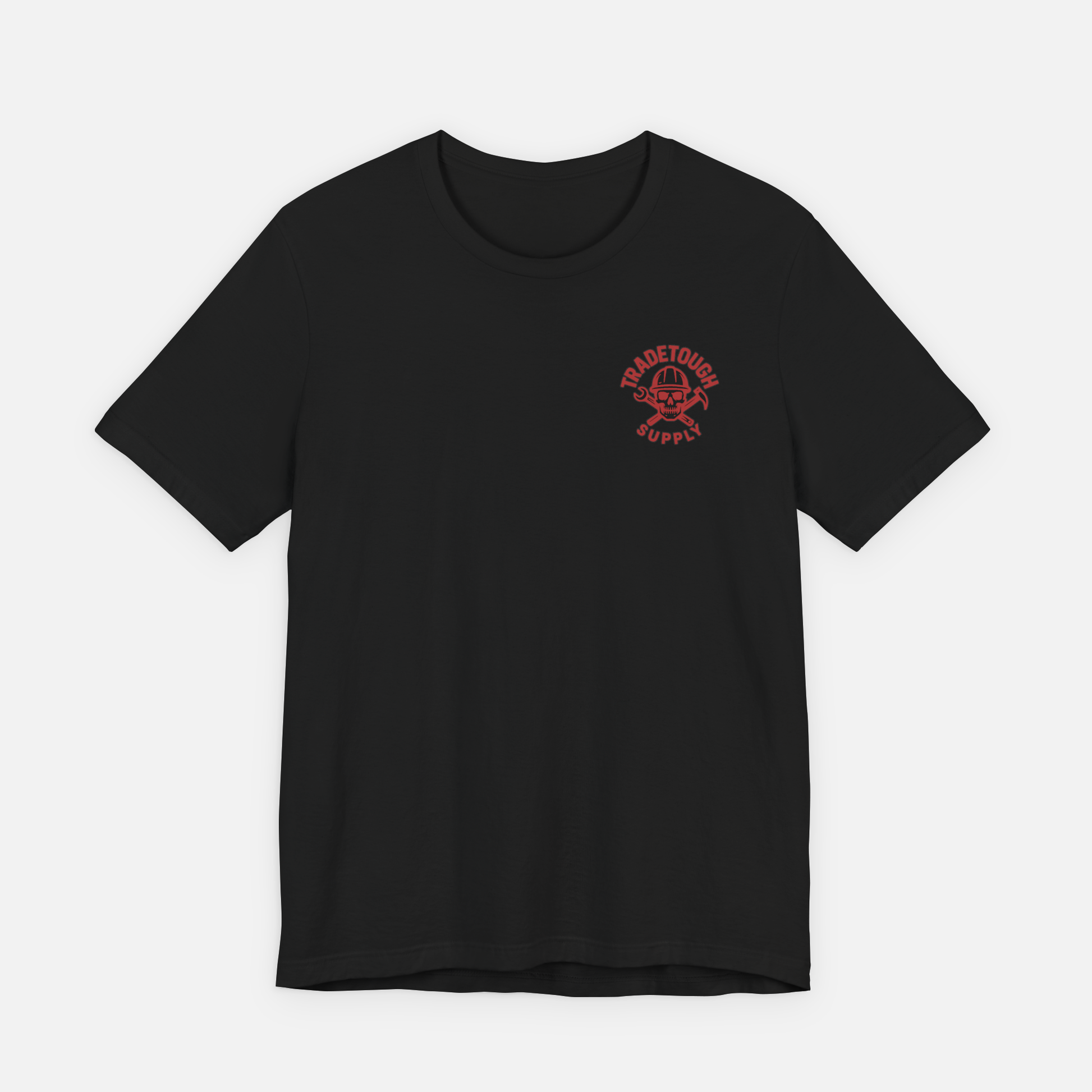 Black t-shirt laid flat with minimal TradeTough Supply logo on chest