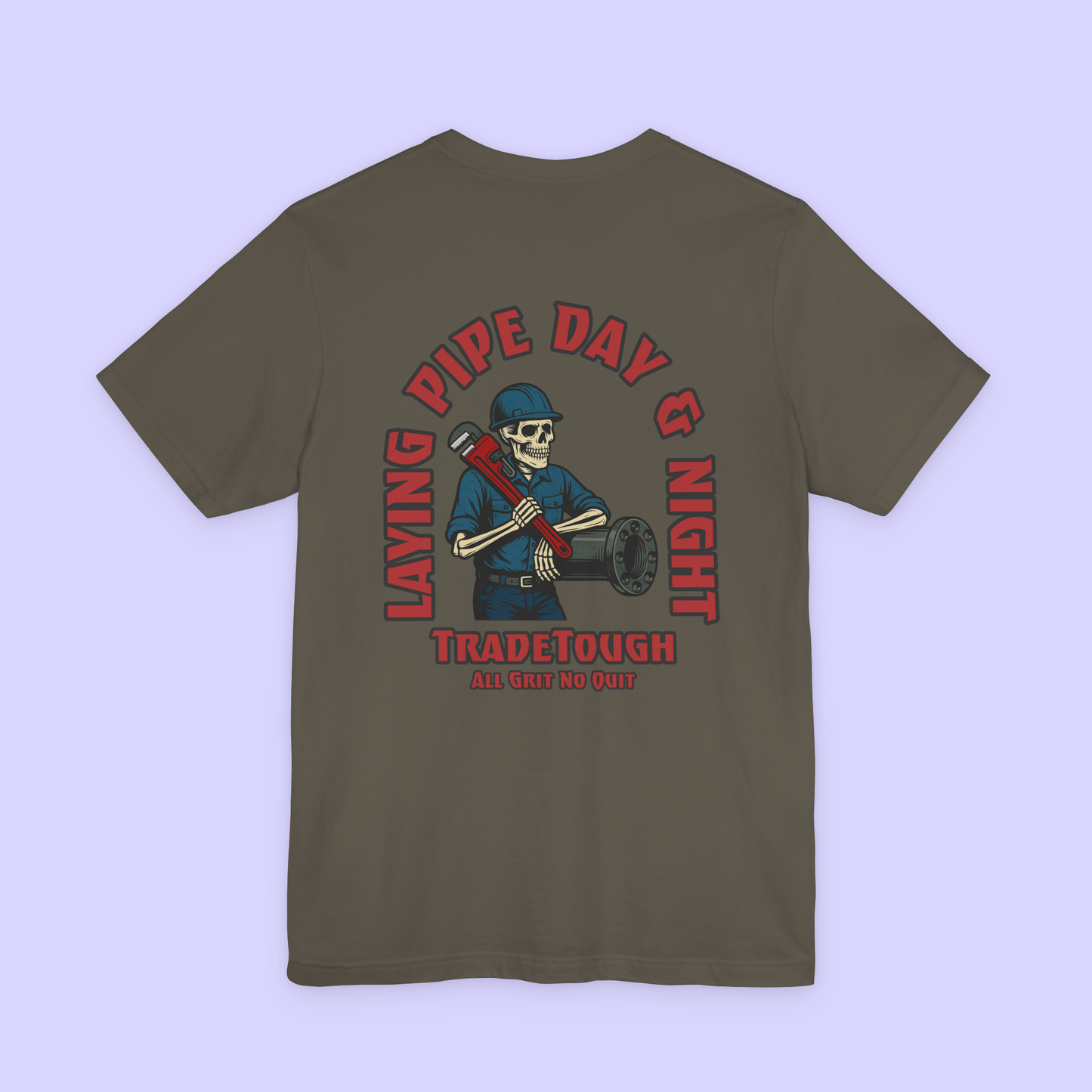 Green t-shirt with a graphic design on the back featuring a skeleton wearing a hard hat and holding pipes, with text 'Laying Pipe Day & Night' and 'Tradetough'.