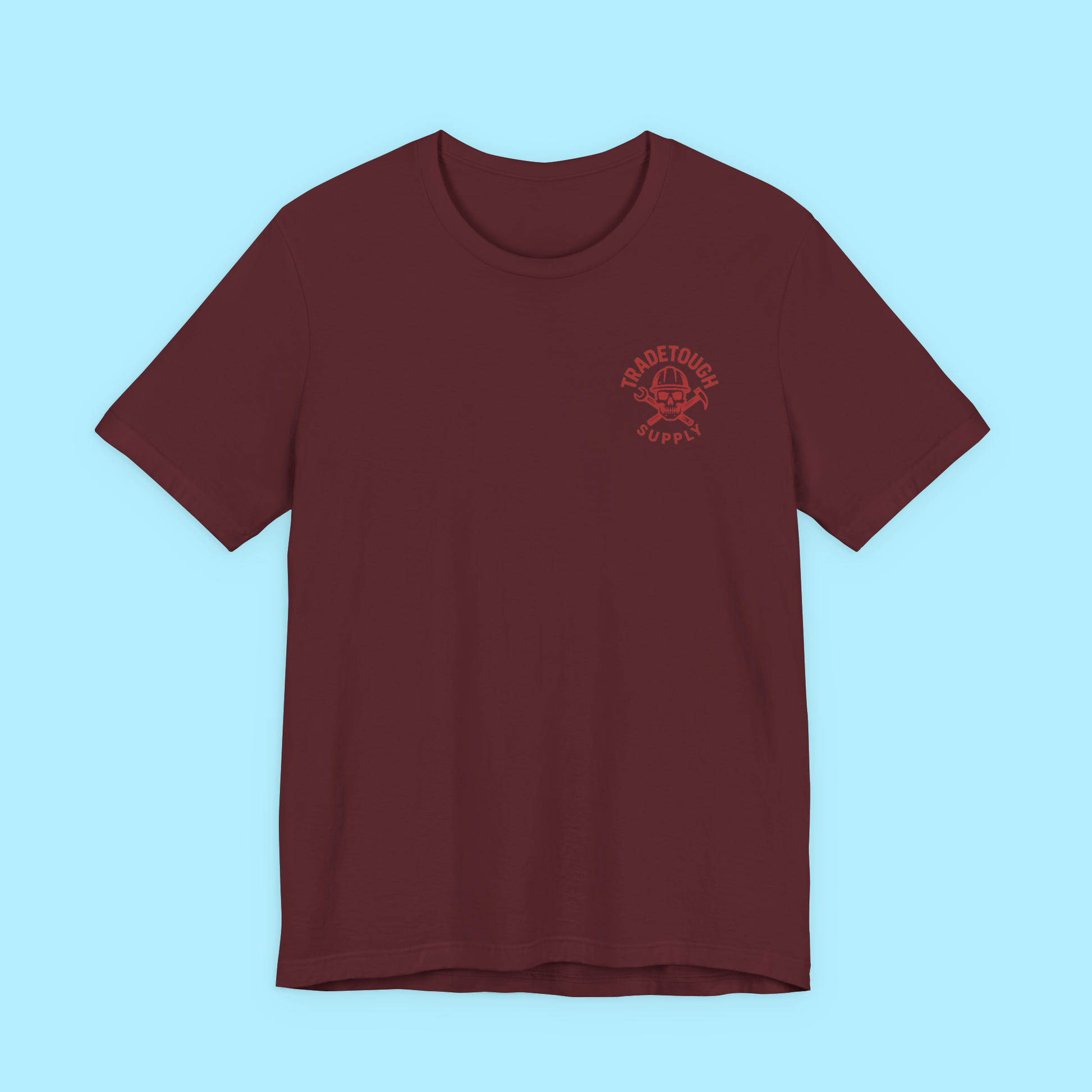 Flat lay of maroon shirt with rust red TradeTough front chest logo