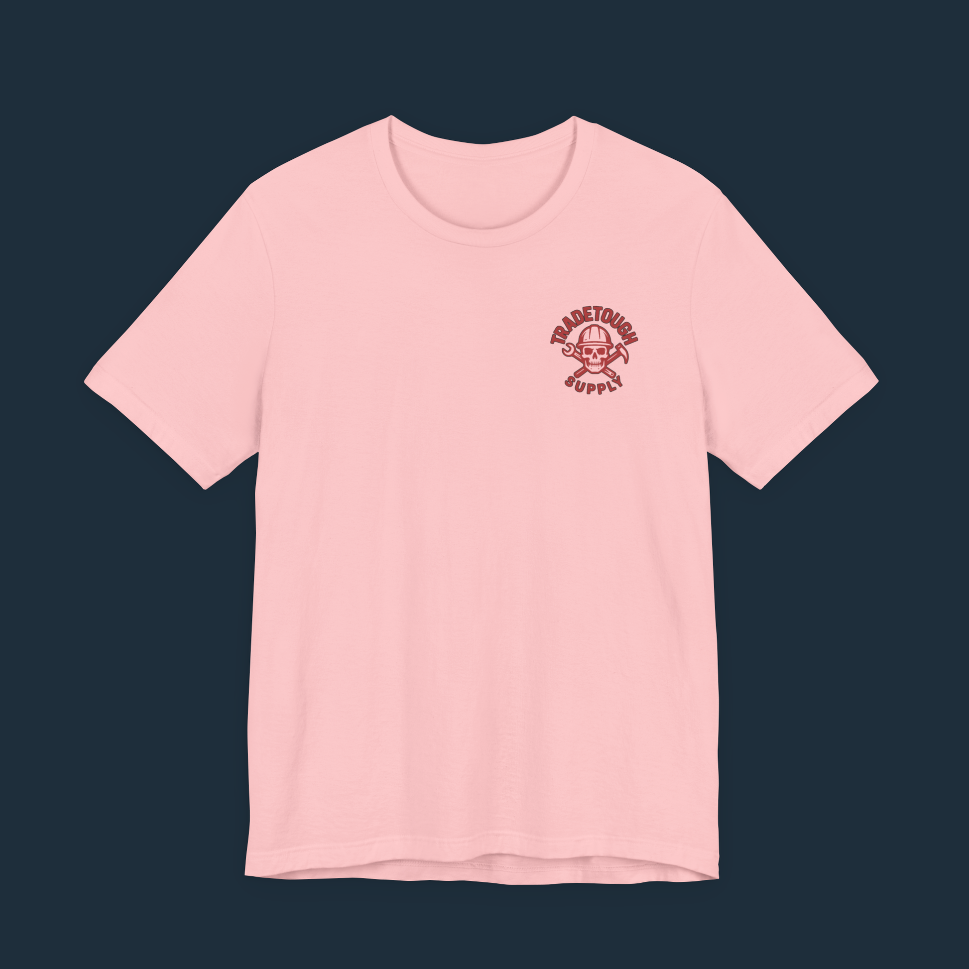Soft pink shirt laid flat showing chest logo — a tough tee with contrast