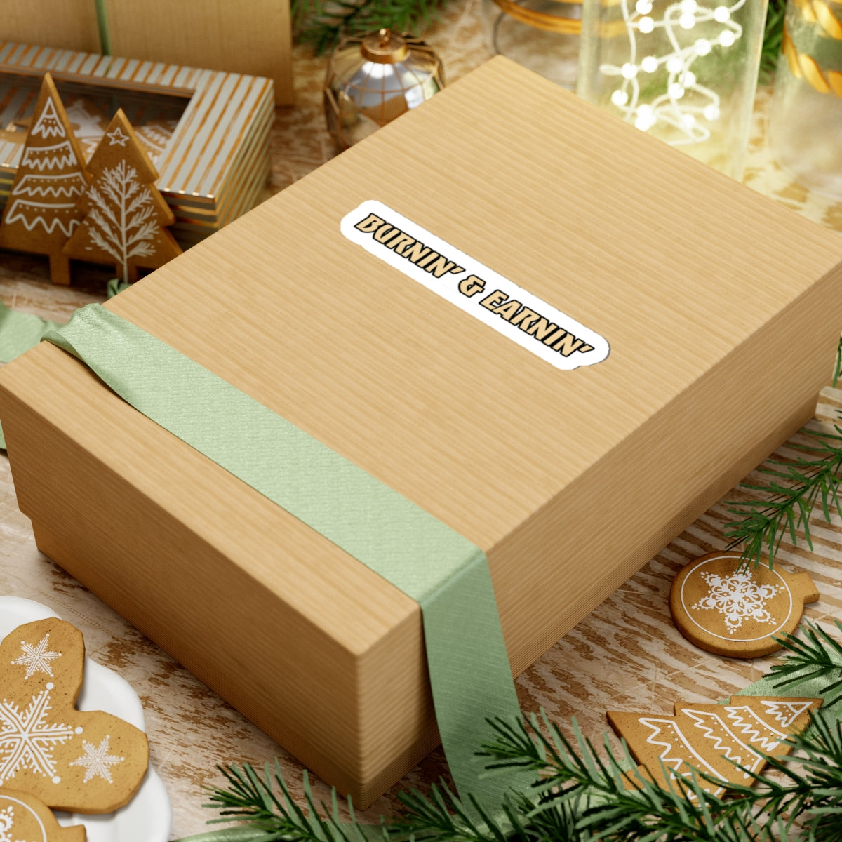 Wooden gift box with a green ribbon and 'Bubba & Bear' label, surrounded by Christmas-themed cookies and decorations.